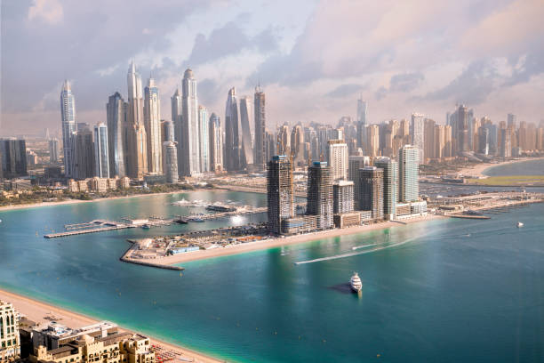 Aerial view of Dubai's skyscrapers and waterfront, illustrating UAE's dynamic real estate market.