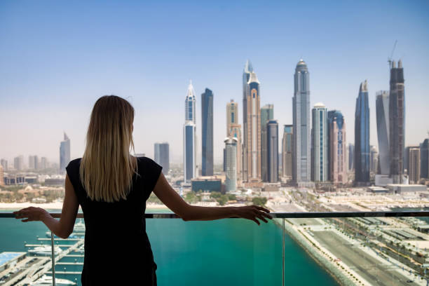 Woman overlooking Dubai skyline, illustrating UAE mortgage lending landscape.