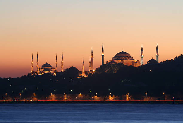 Sunset over a mosque in Dubai illustrates the serene atmosphere during Ramadan, highlighting its property benefits.